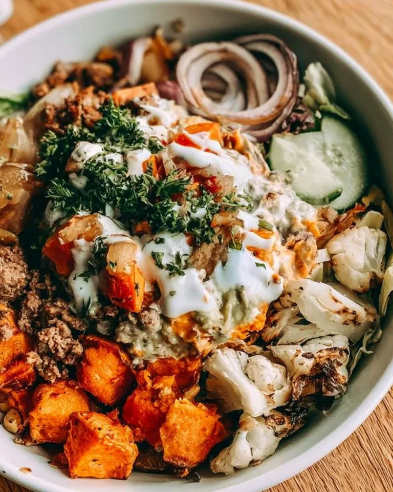 Delicious Burger Bowl with roasted sweet potatoes and fresh toppings.