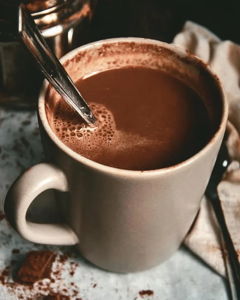 Homemade hot chocolate served in a cozy mug with whipped cream