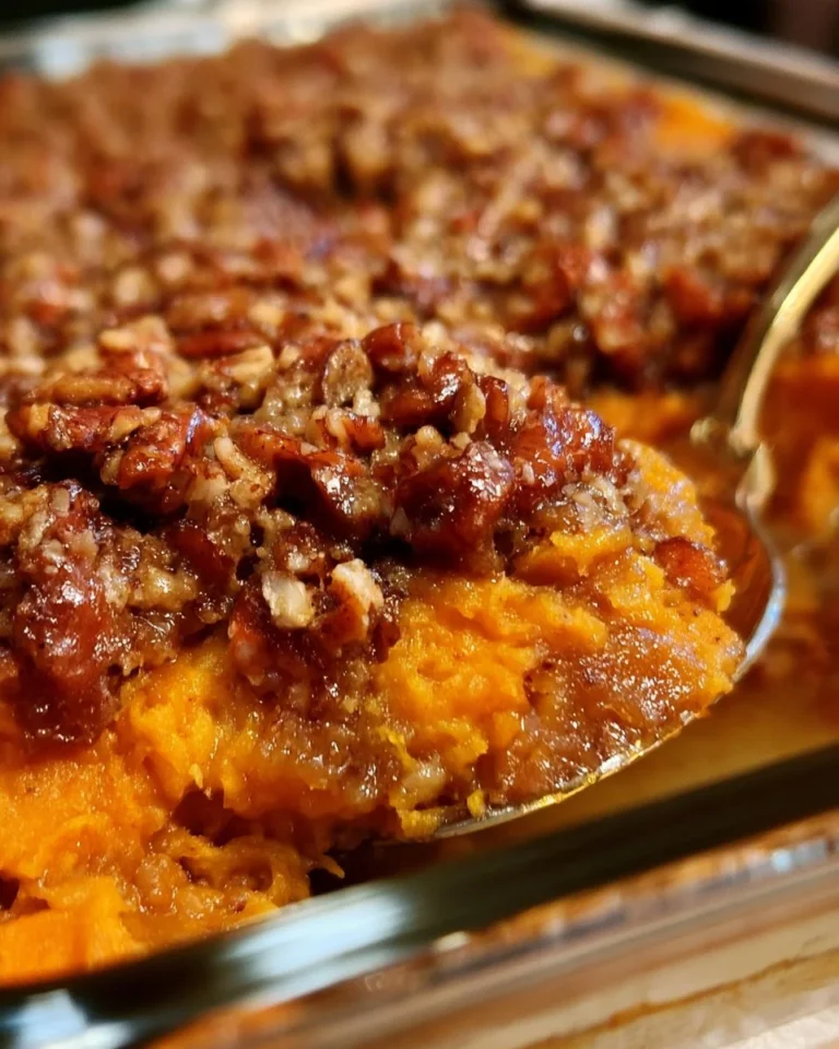 Delicious sweet potato casserole topped with a crunchy pecan praline layer